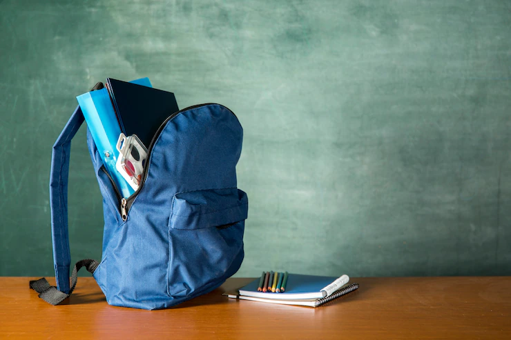 open knapsack with stationery watercolors 23 2148179051